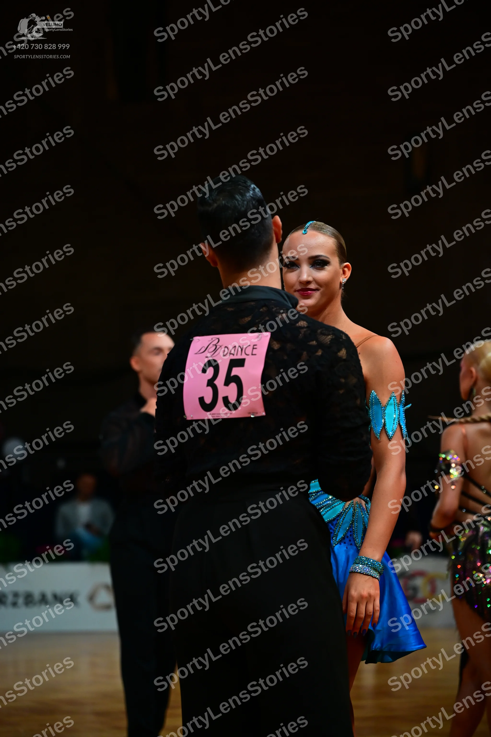 Dancesport competitor #35: Male dancer in foreground: black long-sleeved shirt with a subtle textured patte