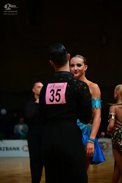 Dancesport competitor #35: Male dancer in foreground: black long-sleeved shirt with a subtle textured patte