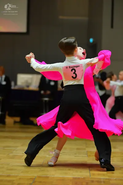 Dancesport competitor: Male dancer: white long-sleeved shirt and black trousers