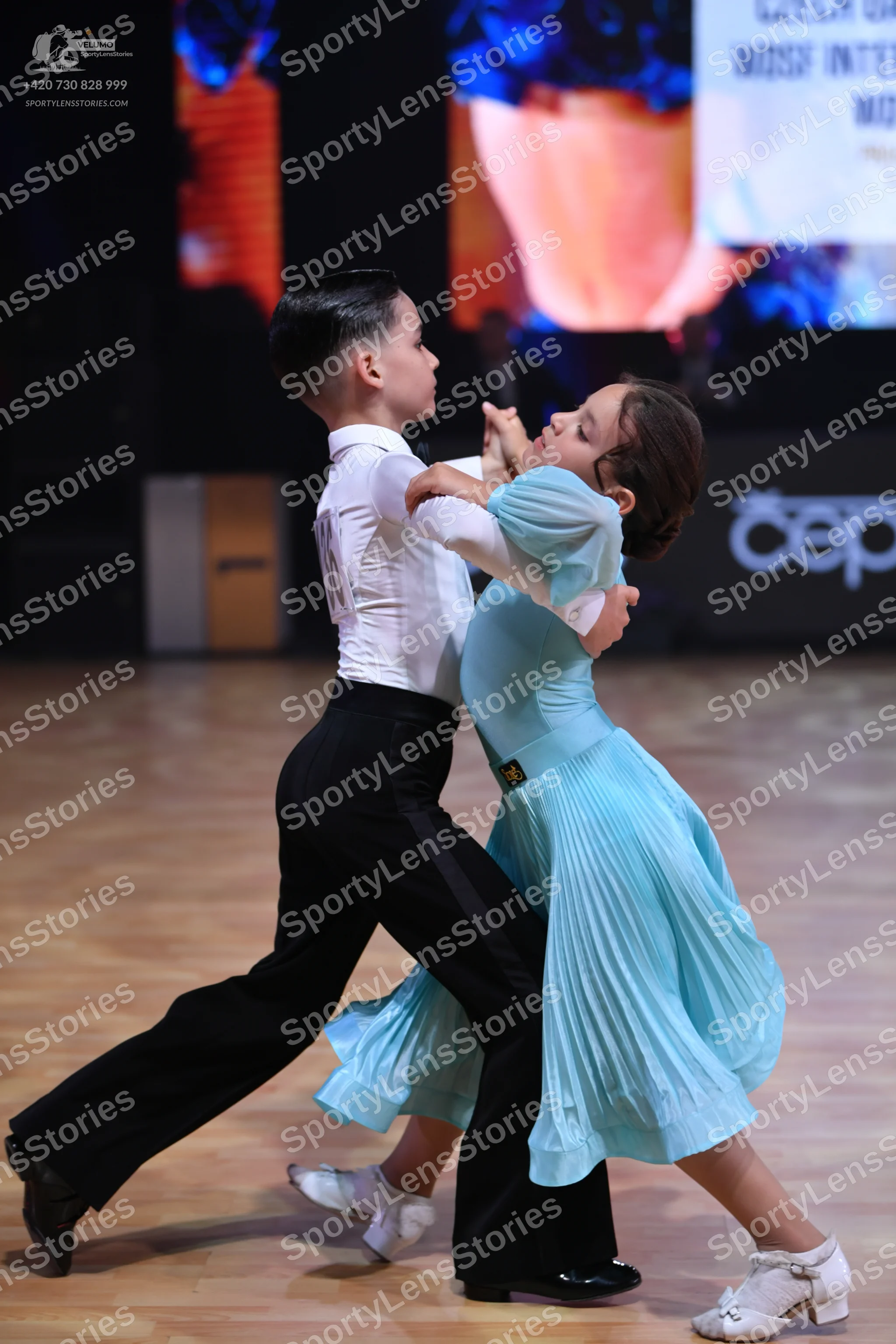 Dancesport competitor: Male dancer: white long-sleeved shirt and black trousers