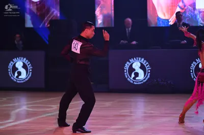 Dancesport competitor: Male dancer: black long-sleeved shirt and black trousers