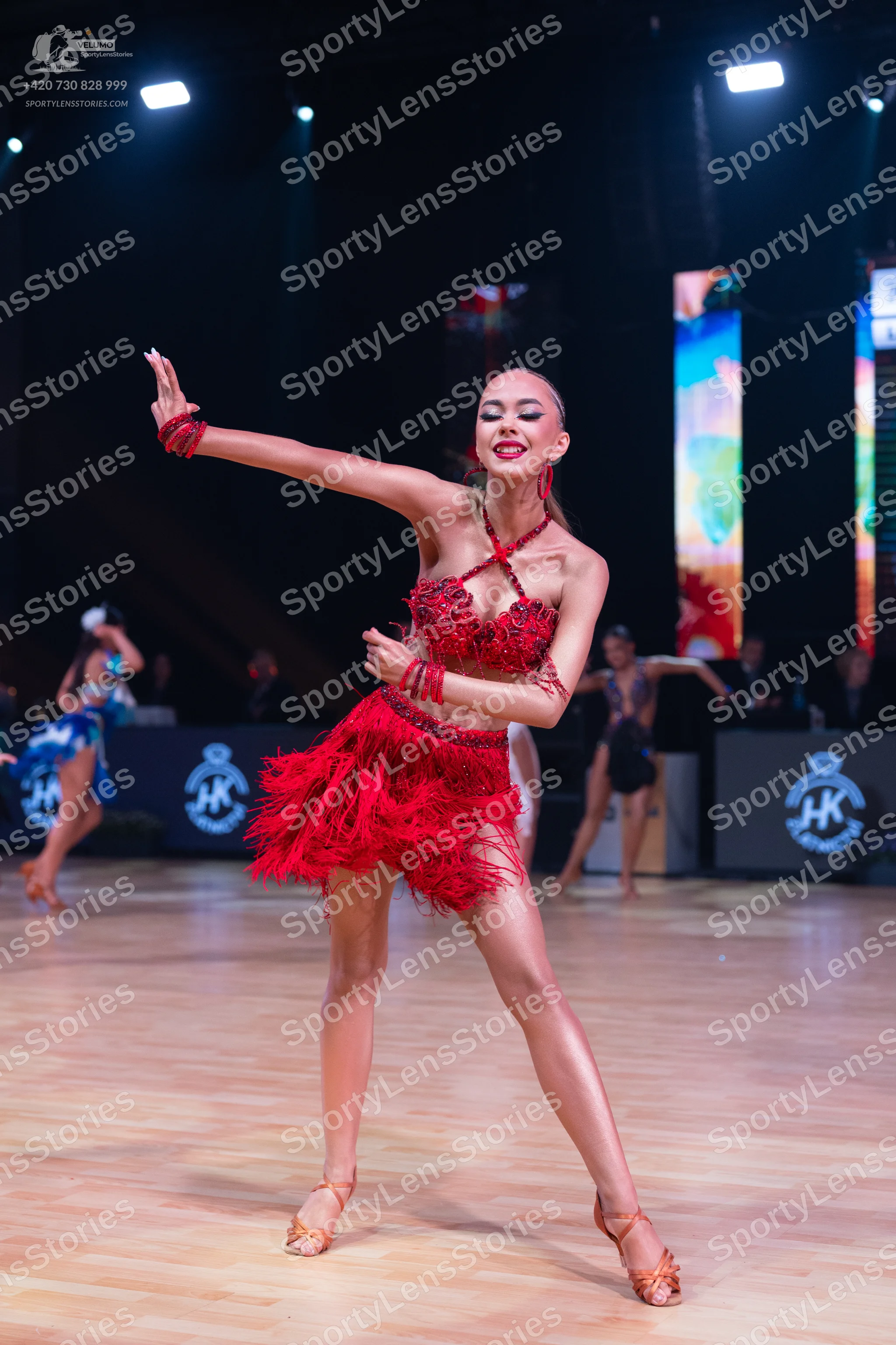 Dancesport competitor: Female dancer: red latin dress with fringe and sequins