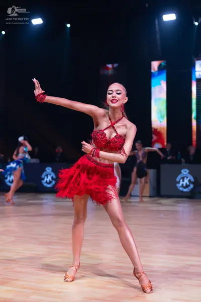 Dancesport competitor: Female dancer: red latin dress with fringe and sequins