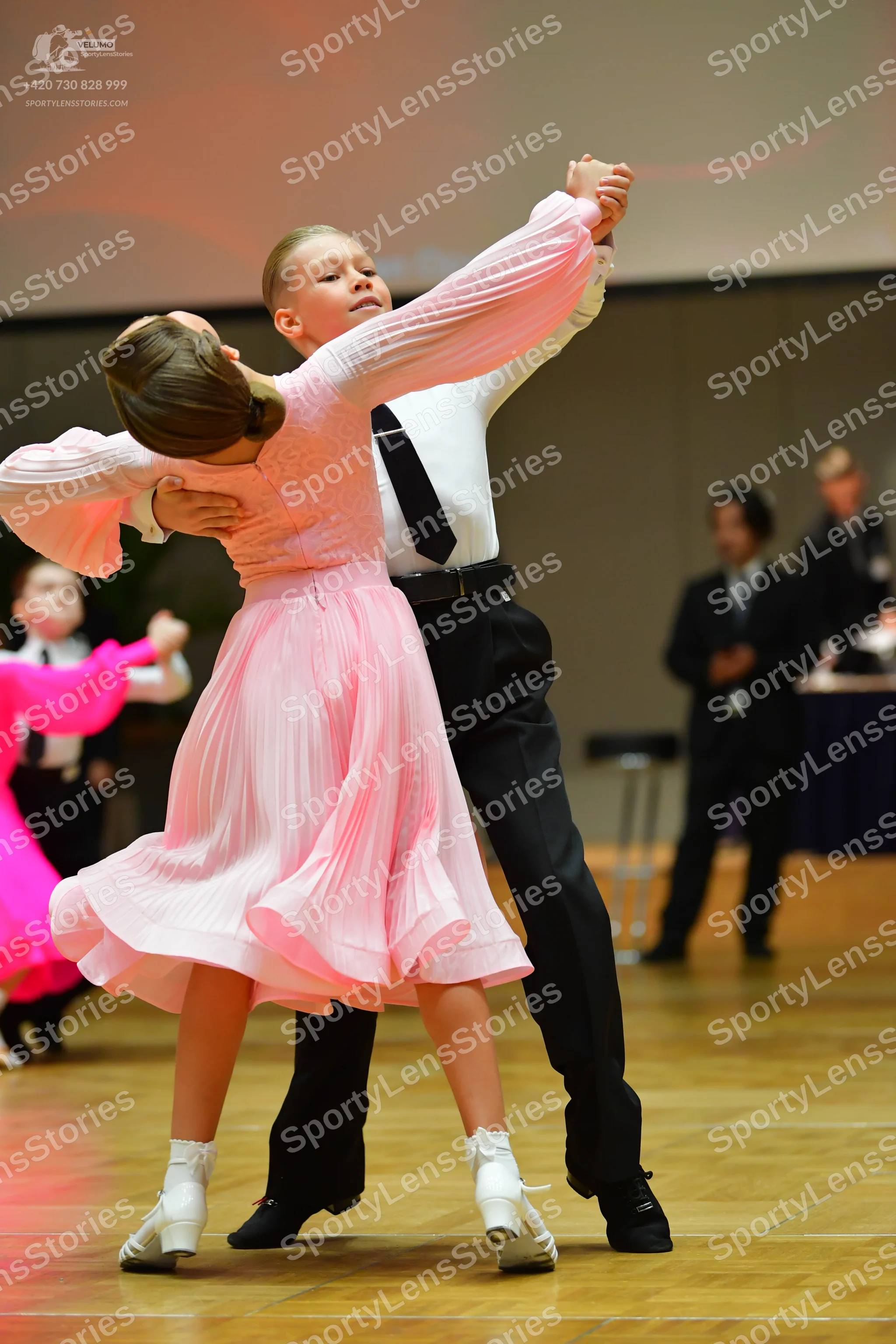 Dancesport competitor: Male dancer: white long-sleeved shirt, black necktie, black trousers, black belt