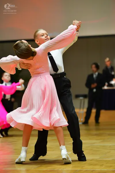Dancesport competitor: Male dancer: white long-sleeved shirt, black necktie, black trousers, black belt