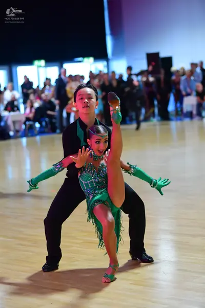 Dancesport competitor: Male dancer: black long-sleeved shirt and black trousers