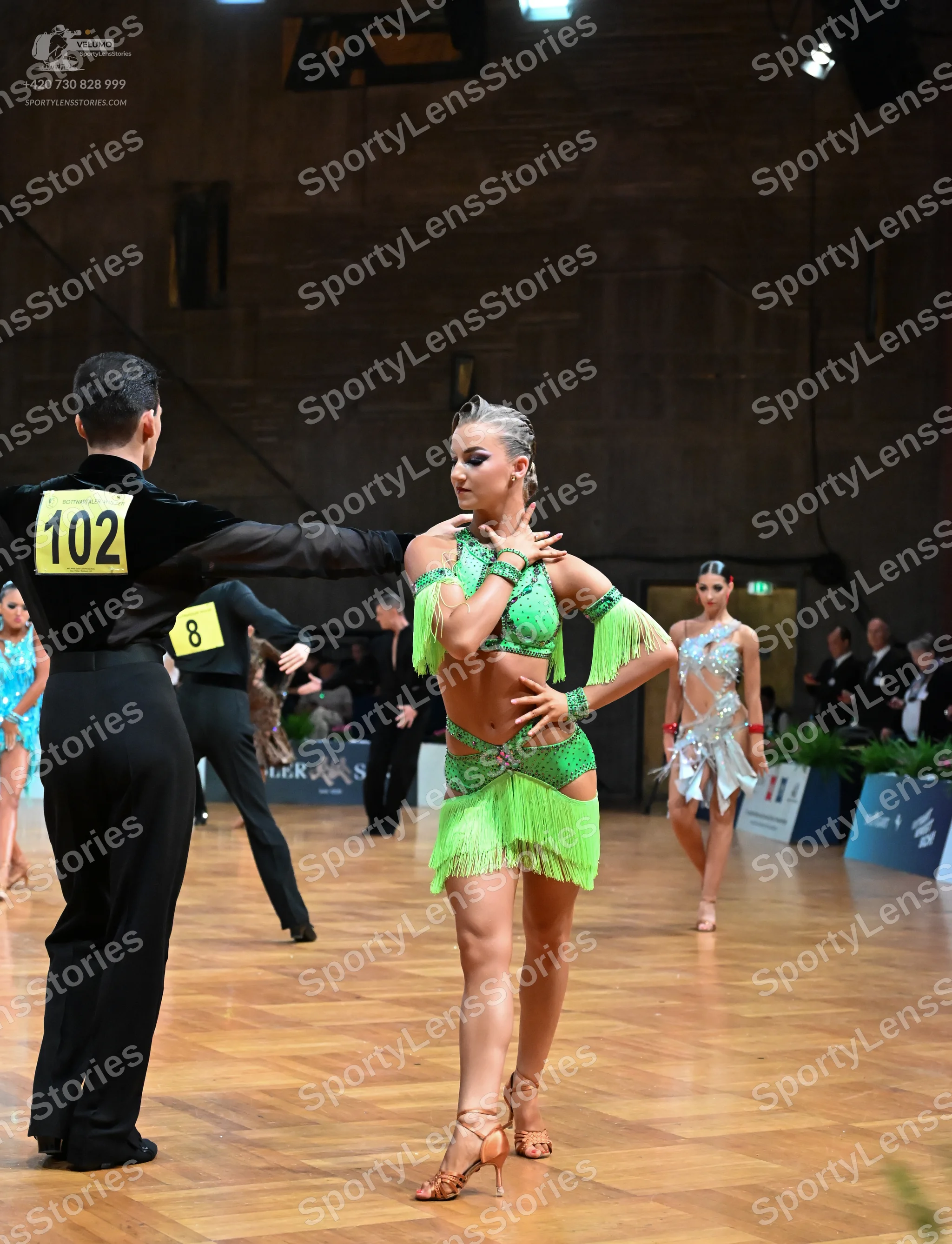 Dancesport competitor #102: Male dancer (foreground): black long-sleeved shirt and black trousers
