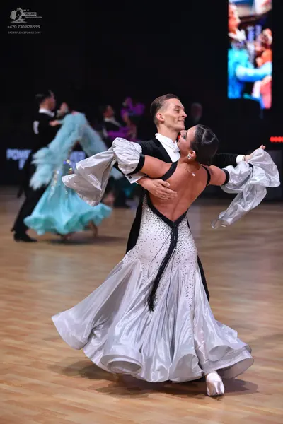 Dancesport competitor: Male dancer: black suit with white shirt
