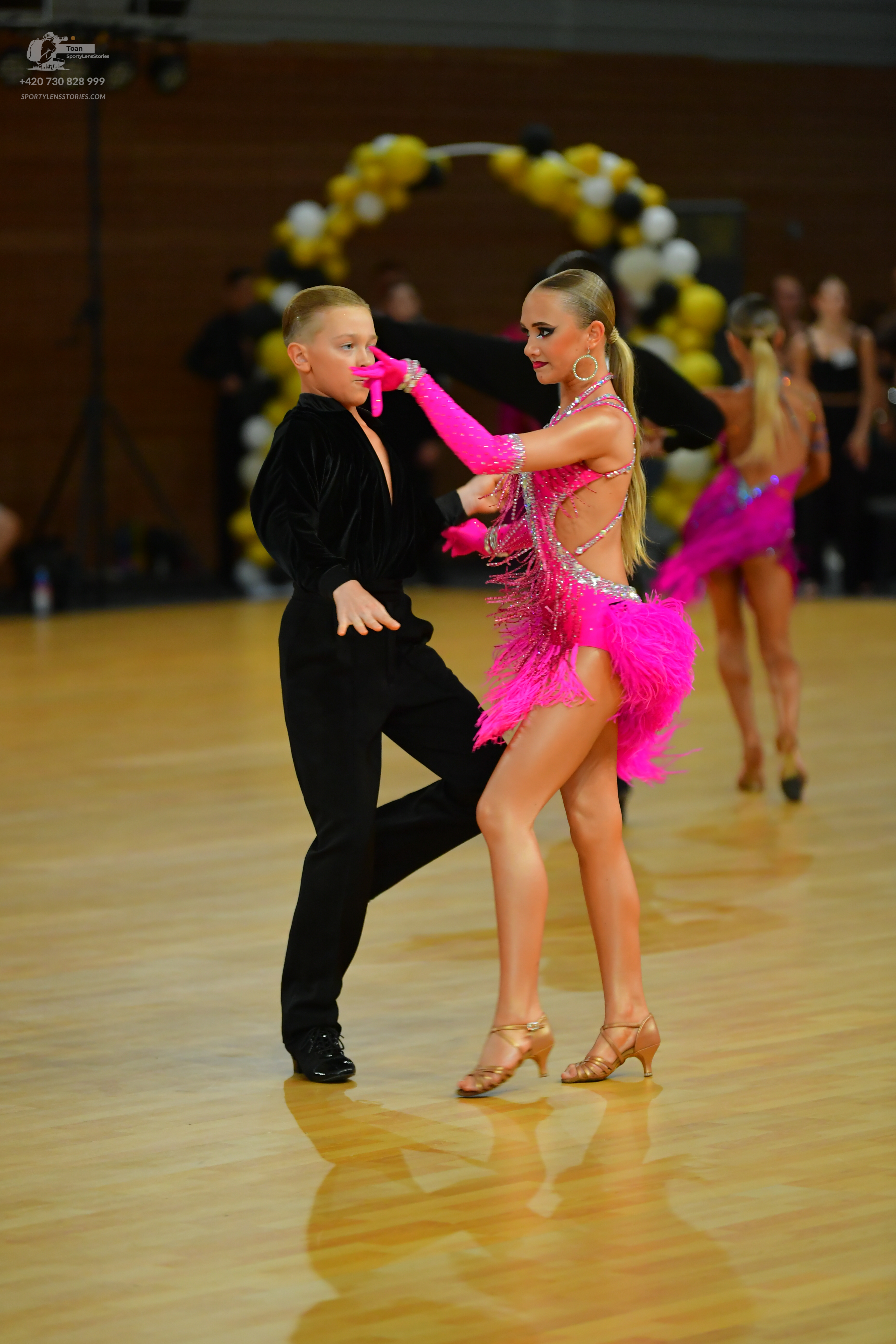 Dancesport competitor: ** Male: Black tailsuit with subtle, iridescent sequins on the lapels