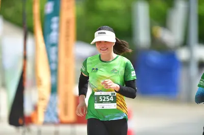 Marathon runner #5254: Runner 1: green and yellow patterned short-sleeve jersey over a black long-sleev