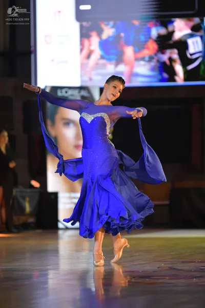 Dancesport competitor #11: Female dancer: royal blue ballroom dress with a sequined bodice and long, flowin