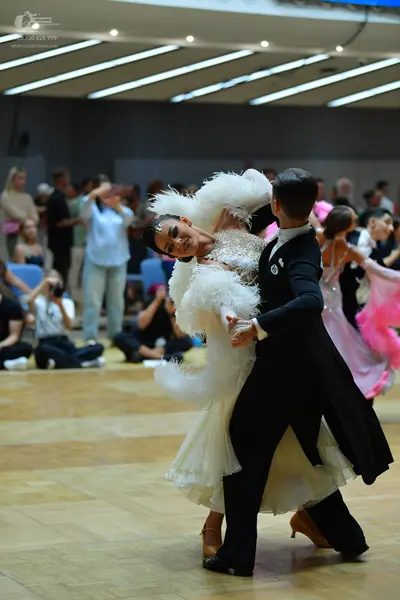 Dancesport competitor: Male dancer: black ballroom tailcoat and trousers with a white shirt