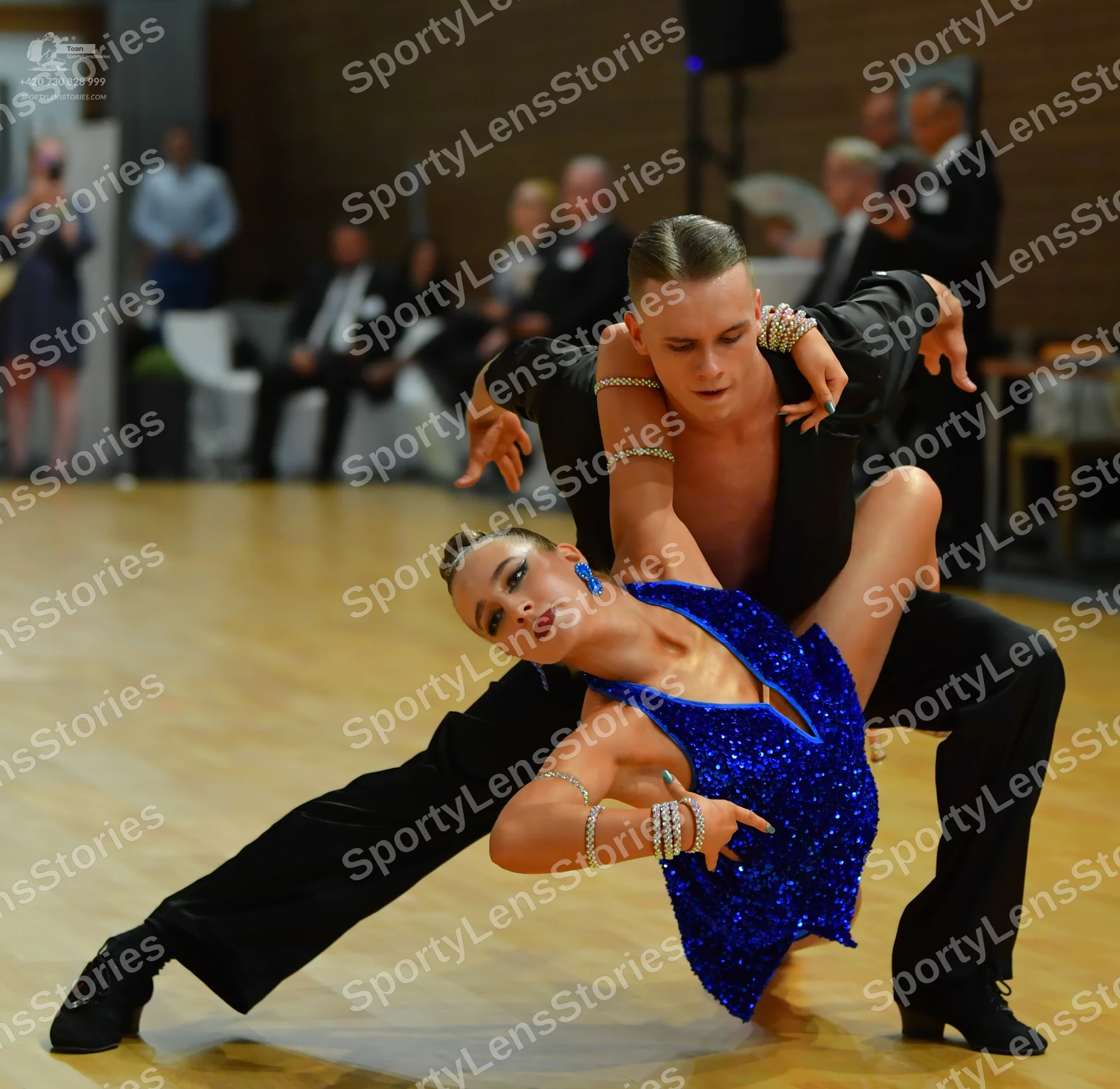 Dancesport competitor: ** Black suit with a long, flowing, sequined tail
