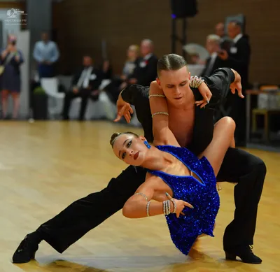 Dancesport competitor: ** Black suit with a long, flowing, sequined tail