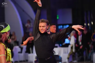 Dancesport competitor: Male dancer: black long-sleeved dance top