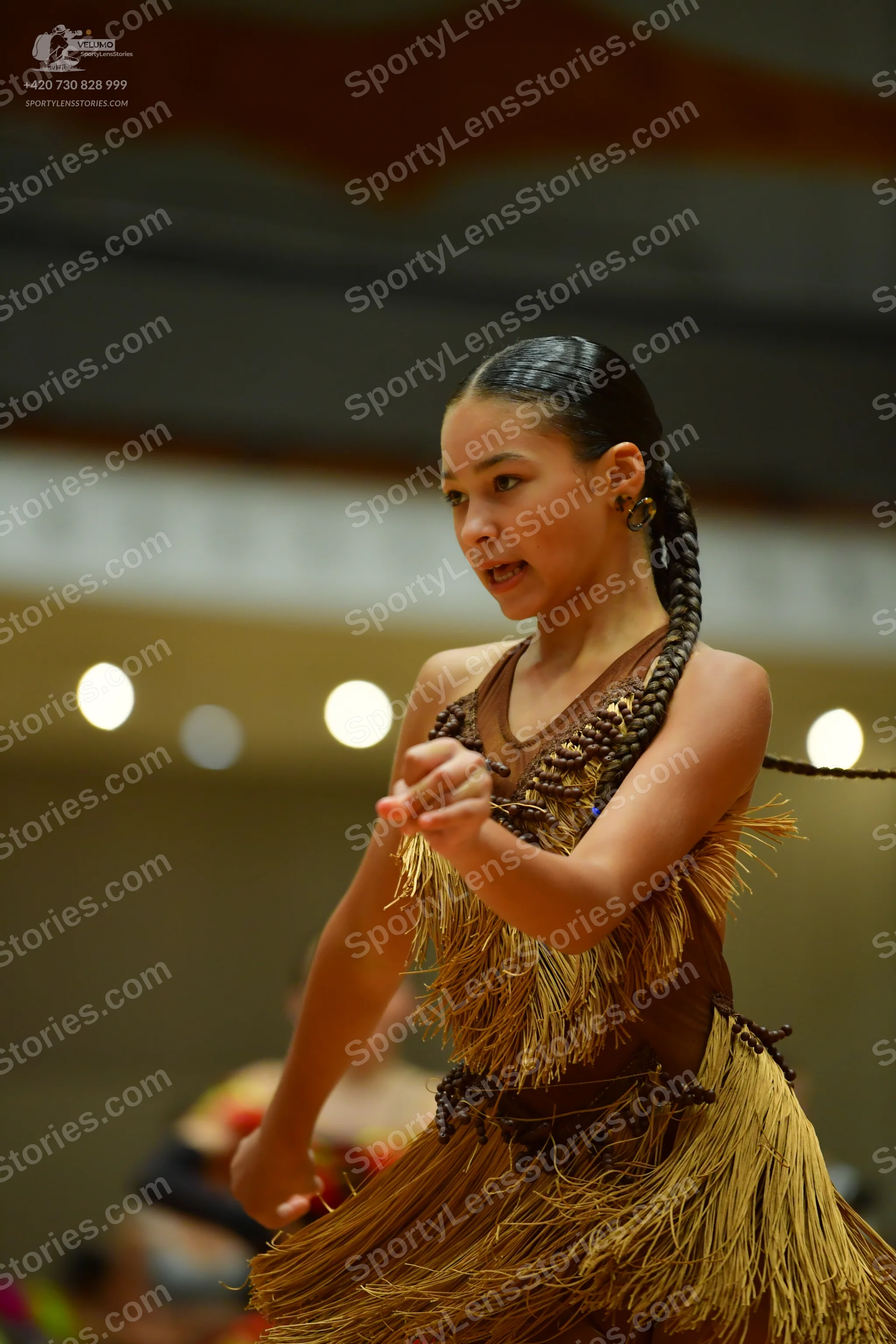 Dancesport competitor: Female dancer: brown Latin dance dress with long fringe and dark brown decorativ