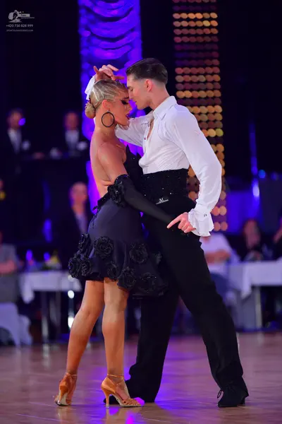 Dancesport competitor: Male dancer: white long-sleeved shirt and black trousers