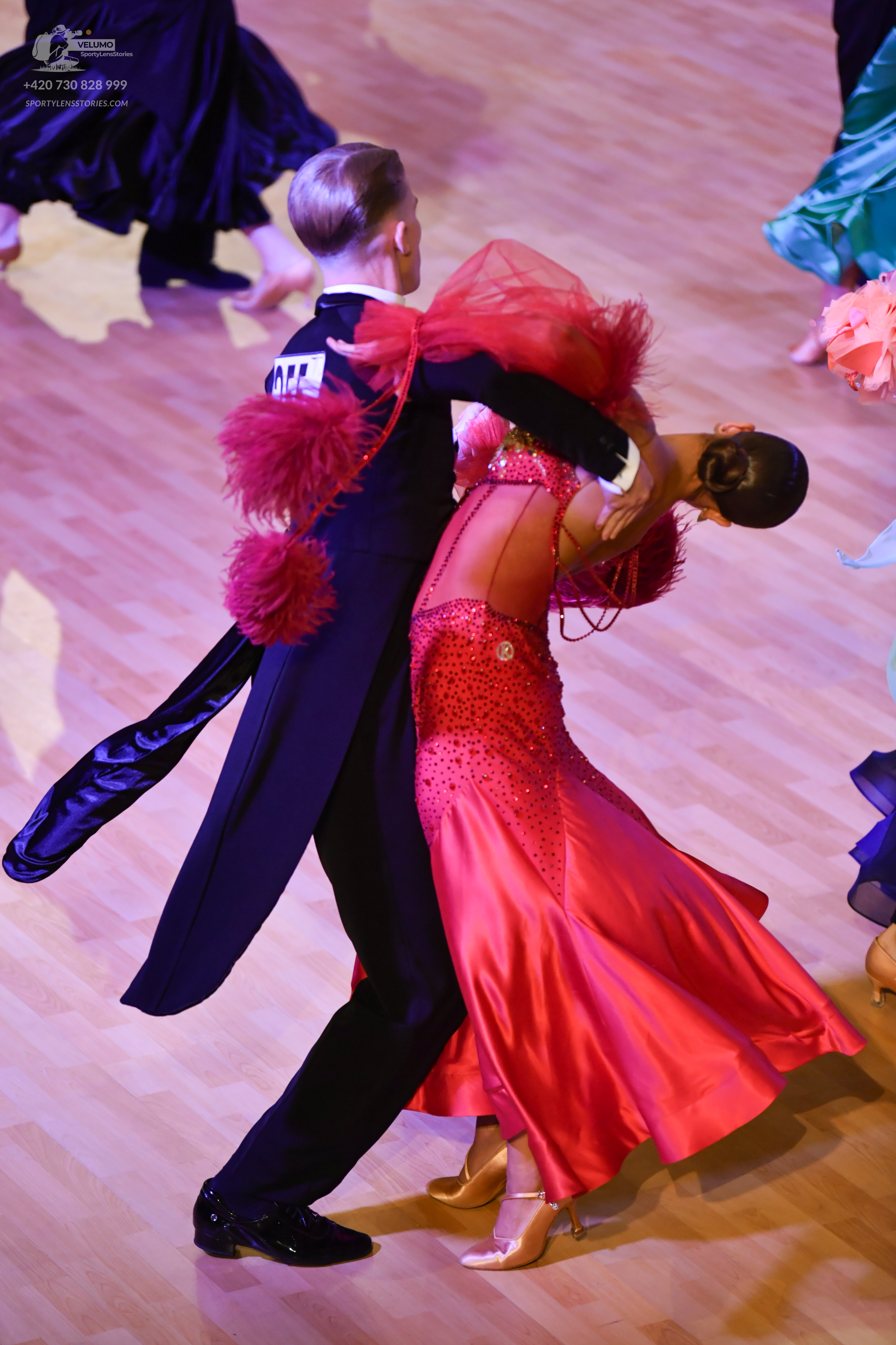 Dancesport competitor: ** Black tailsuit
*   **Fabric:** Appears to be a satin or silk blend