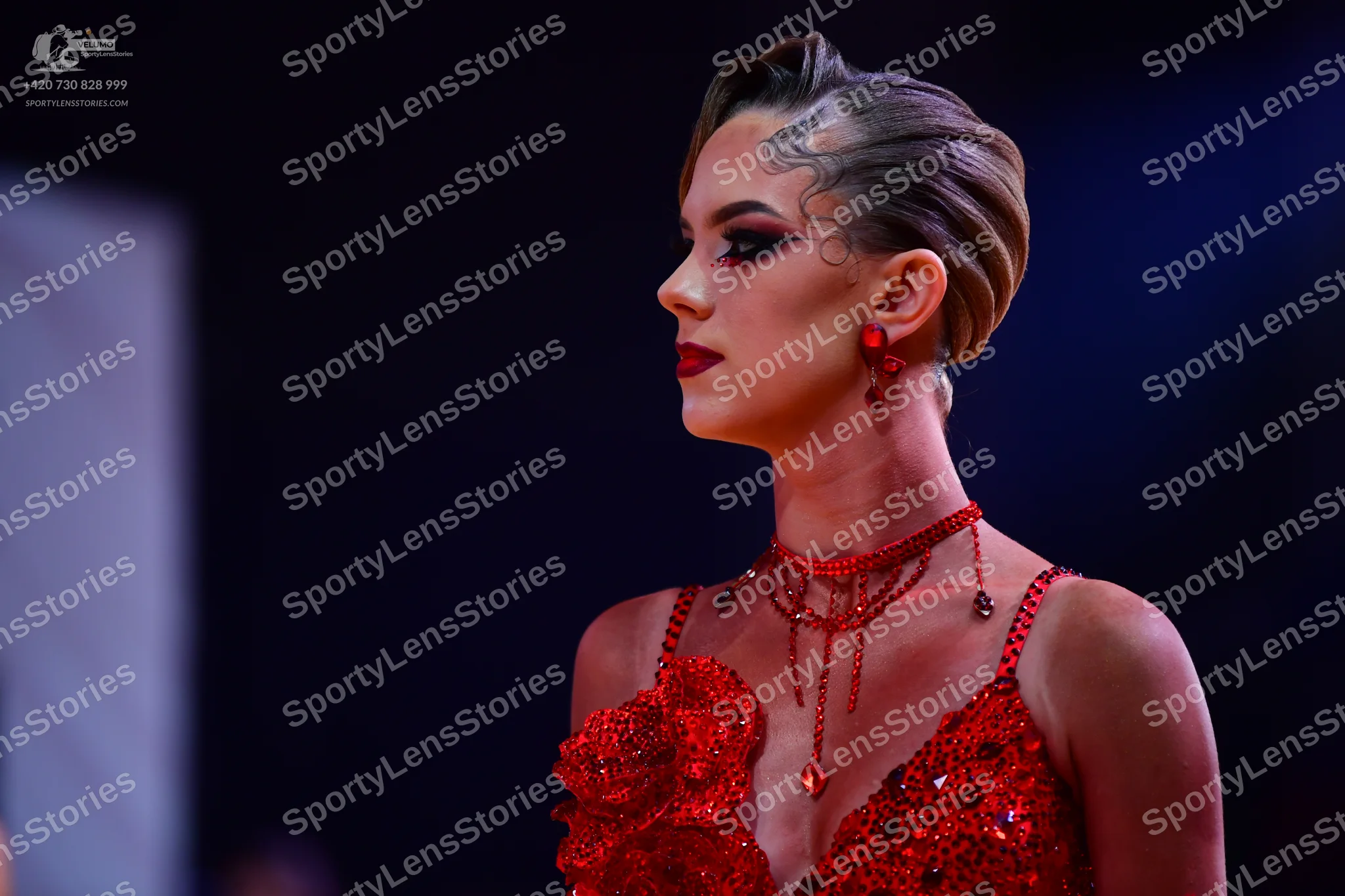 Dancesport competitor: Female dancer: red latin dress with sequins and embellishments, with a matching