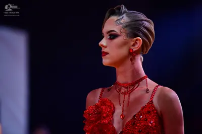 Dancesport competitor: Female dancer: red latin dress with sequins and embellishments, with a matching 