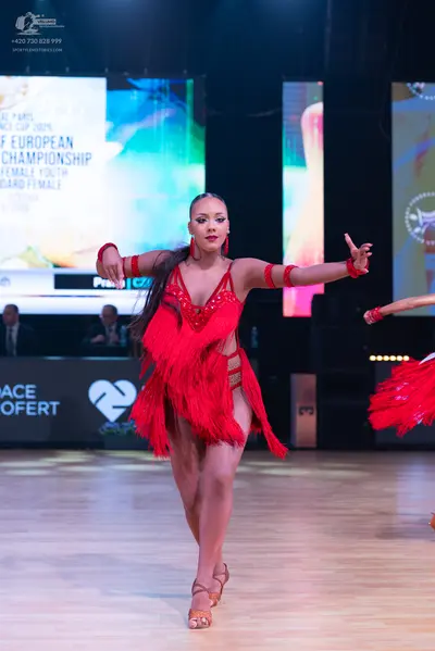 Dancesport competitor: Female dancer: red latin dress with fringe