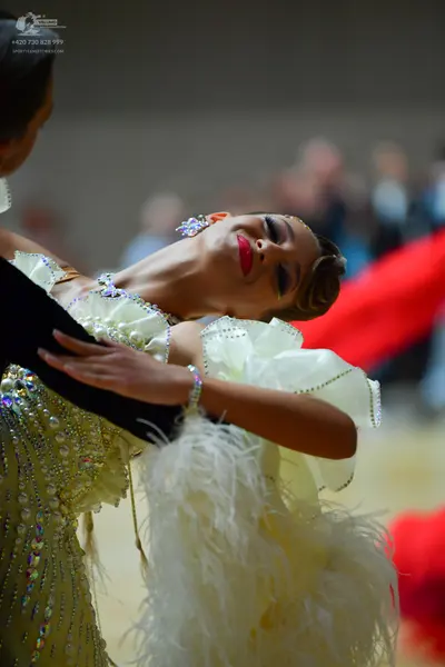 Dancesport competitor: Male dancer: black garment with some sequin detail visible on the shoulder