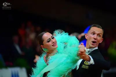 Dancesport competitor: Female dancer: mint green costume with voluminous, feathery texture