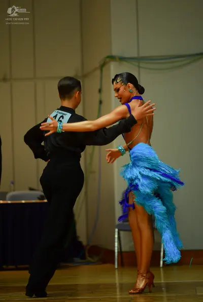 Dancesport competitor: Male dancer: black long-sleeved shirt and black trousers