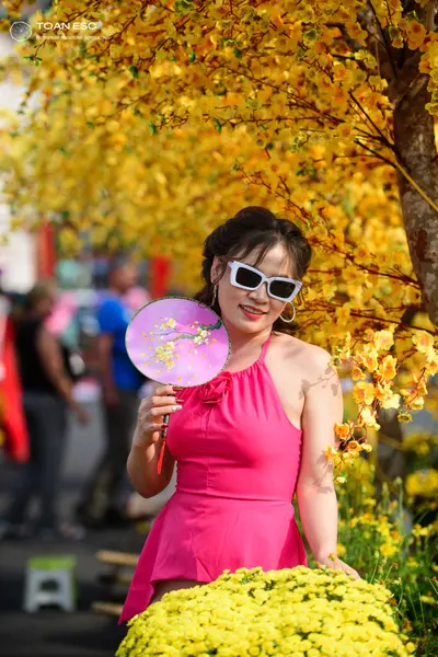 Dancesport competitor: Female dancer: bright pink sleeveless Latin dress with a halter neck and a small
