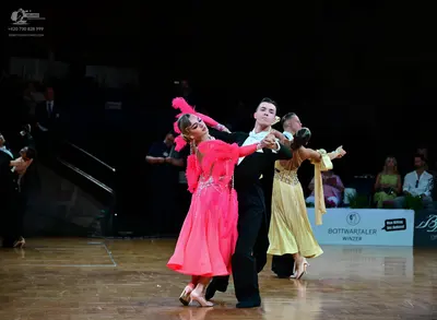 Dancesport competitor: Female dancer: pink Latin dress with lace bodice and a flowy skirt