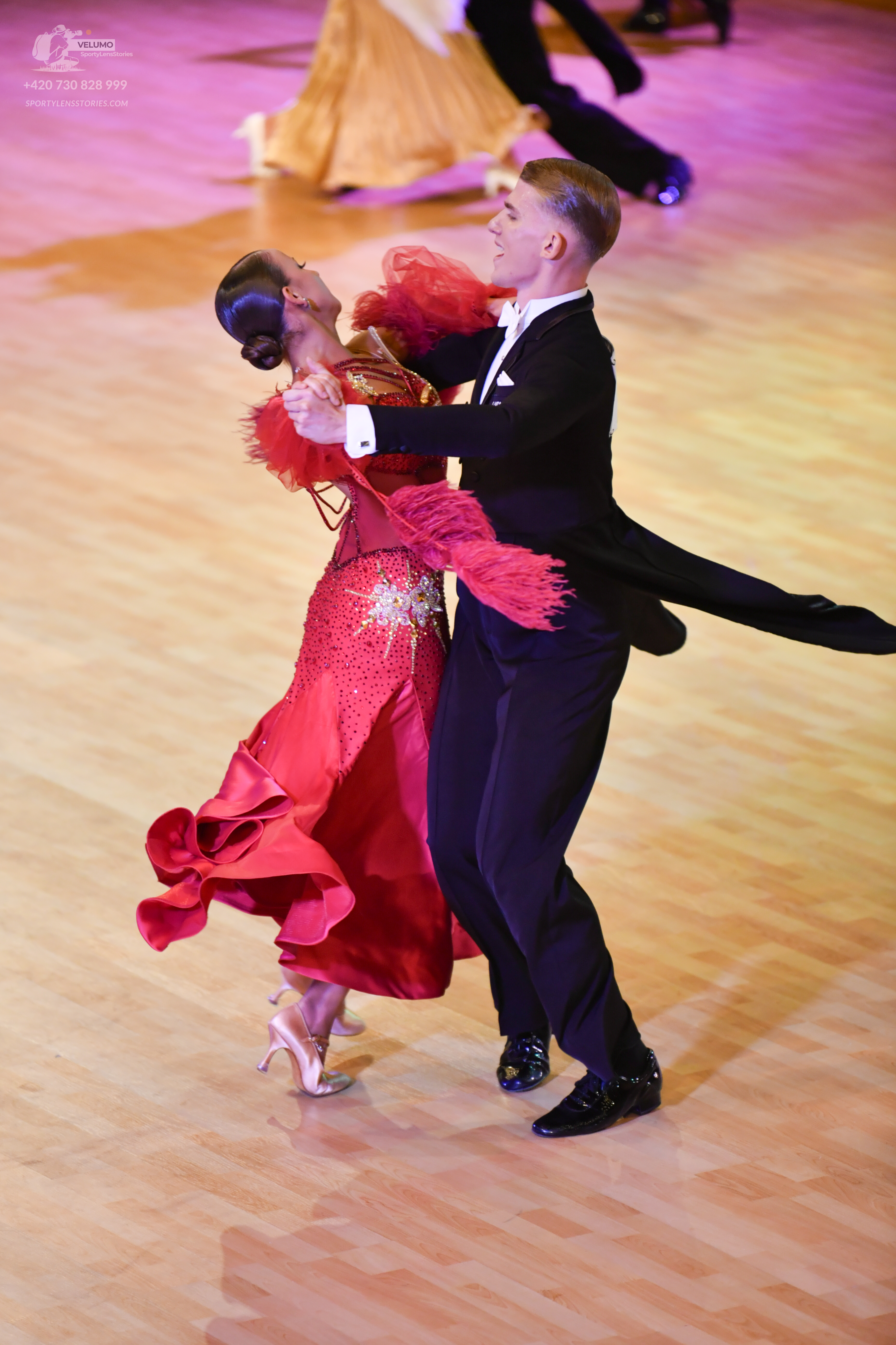 Dancesport competitor: Male:** Black tail suit with a satin jacket and matching pants