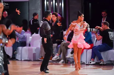 Dancesport competitor: Male dancer: black long-sleeved sequin shirt and black trousers