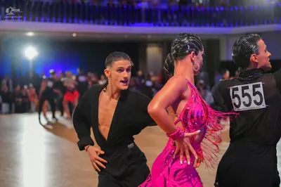 Dancesport competitor #555: Male dancers: black long-sleeved shirts and black trousers