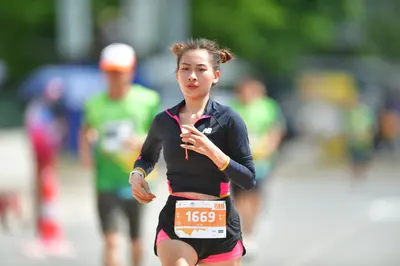 Marathon runner #1669: Runner 1: black long-sleeved top with pink trim, black shorts with pink trim, wh