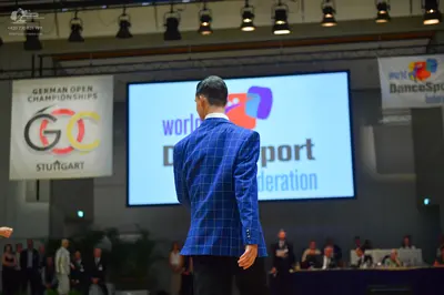 Dancesport competitor: Male dancer: blue plaid blazer and black trousers