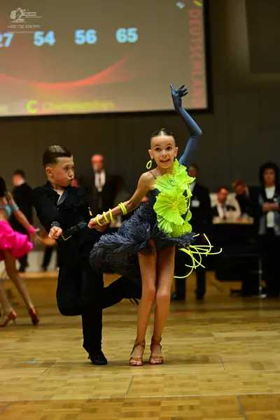 Dancesport competitor: Male dancer: black long-sleeved shirt and black trousers
