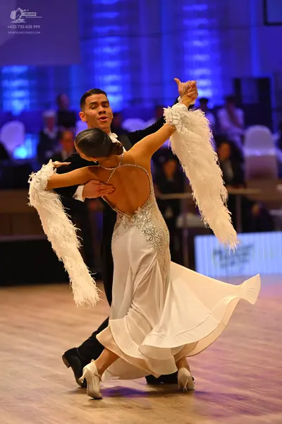 Dancesport competitor: Male dancer: black suit with a white shirt and black bow tie