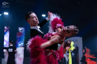 Dancesport competitor: Male dancer: black suit with a white shirt and white bowtie