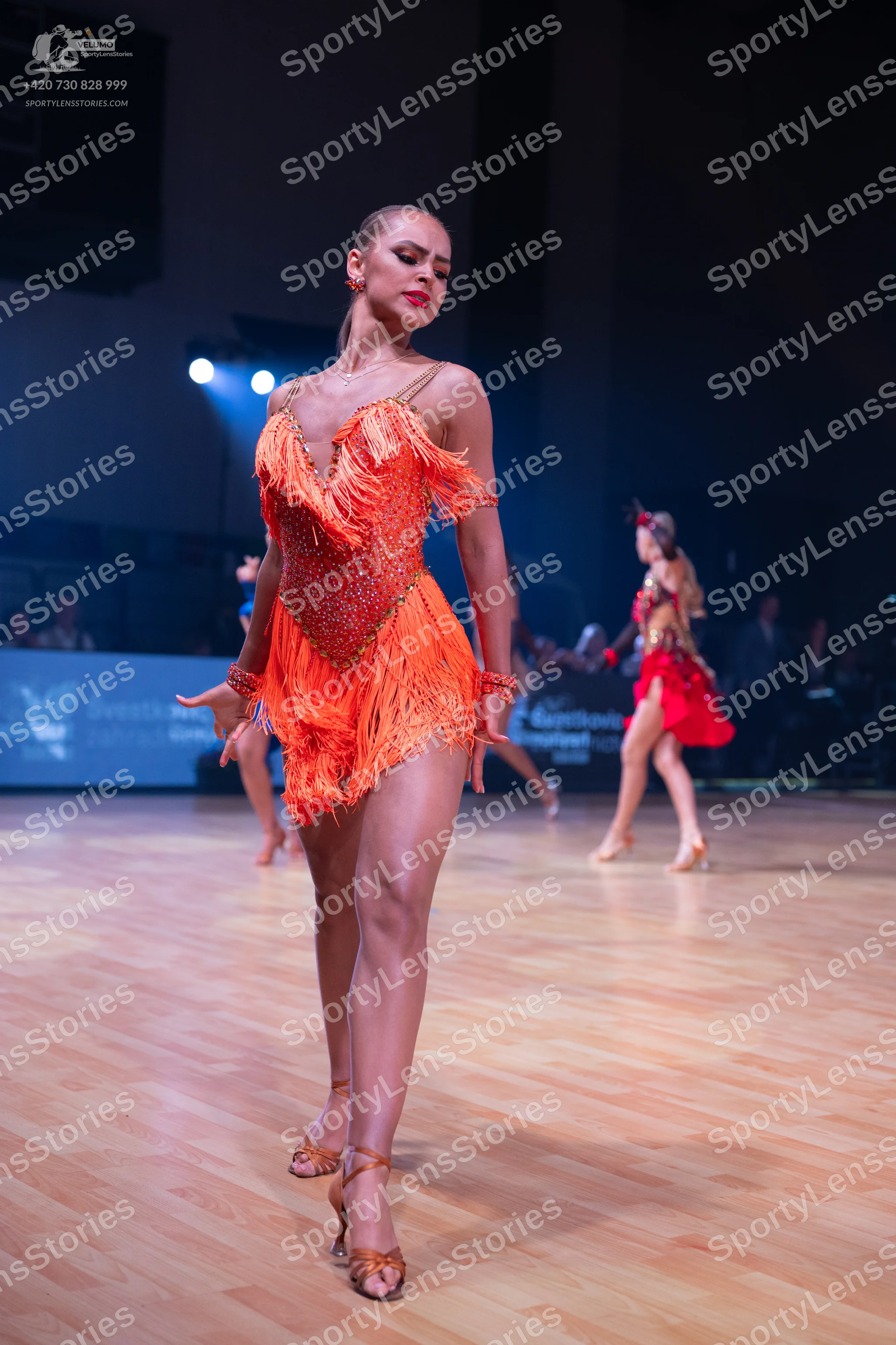 Dancesport competitor: Main dancer: orange latin dress with fringe and sequins