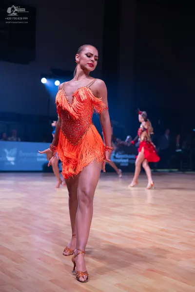 Dancesport competitor: Main dancer: orange latin dress with fringe and sequins