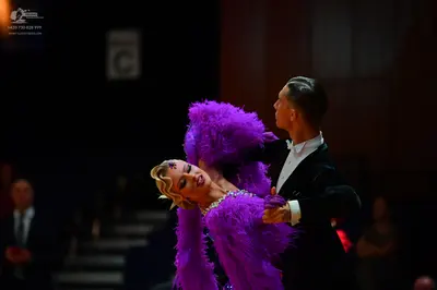 Dancesport competitor: Male dancer: black suit with a white shirt and white bow tie