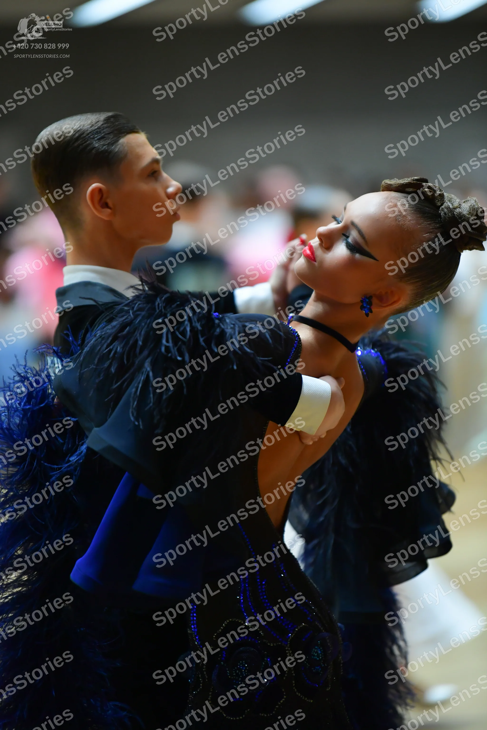 Dancesport competitor: Male dancer: black suit jacket with a white shirt cuff visible