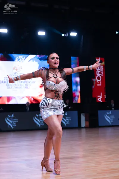 Dancesport competitor: Female dancer: silver sequin latin dress with fringe/feather-like embellishments