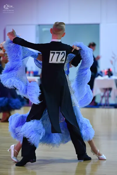 Dancesport competitor #772: Male dancer: black tailcoat with a white collar, black trousers, and black dance