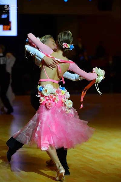 Dancesport competitor: Female dancer: pink and white latin dress with a voluminous pink tulle skirt, de