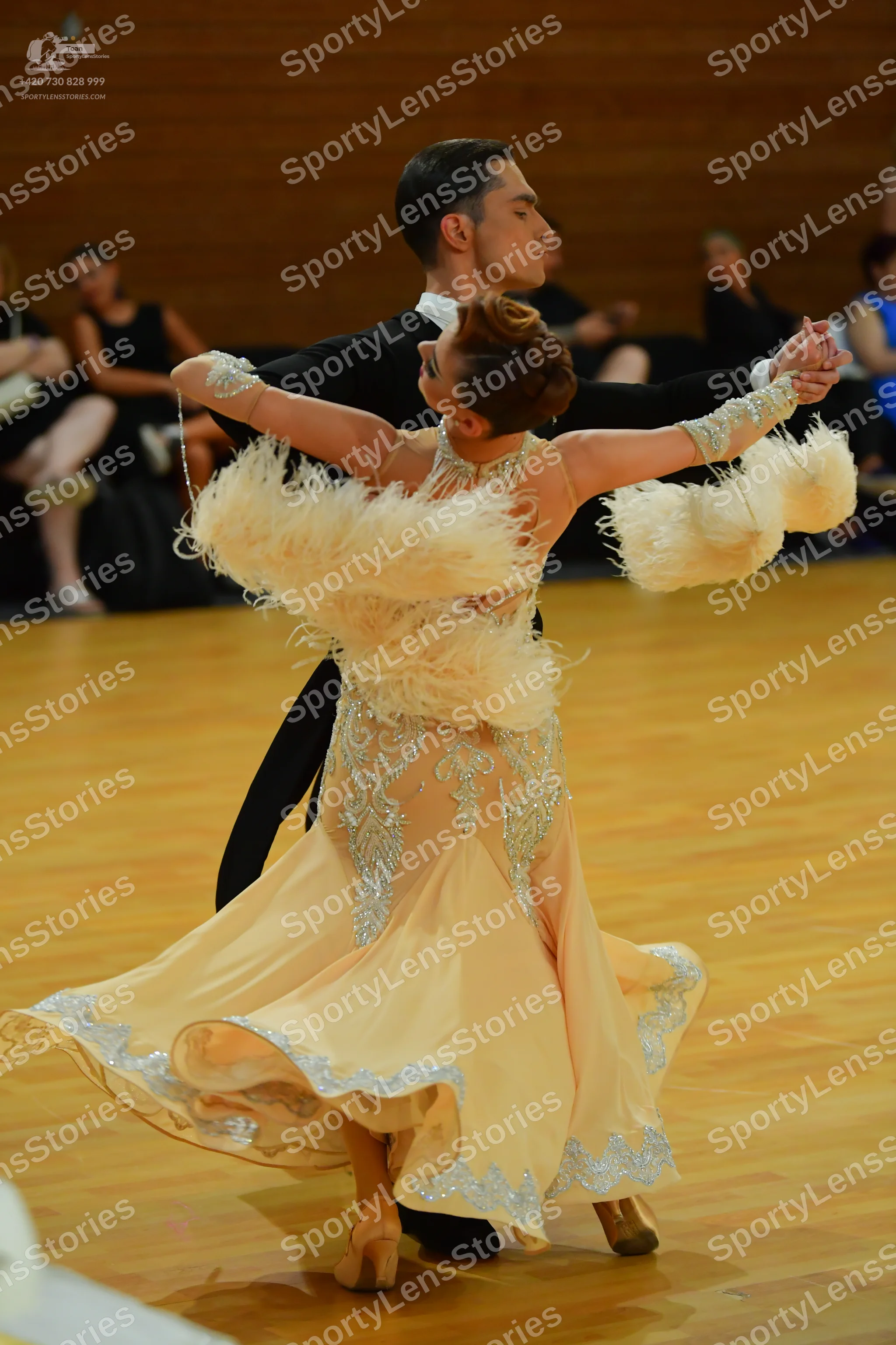 Dancesport competitor: Male:** Black tailsuit with sequin lapels, black shoes, and a black wristband