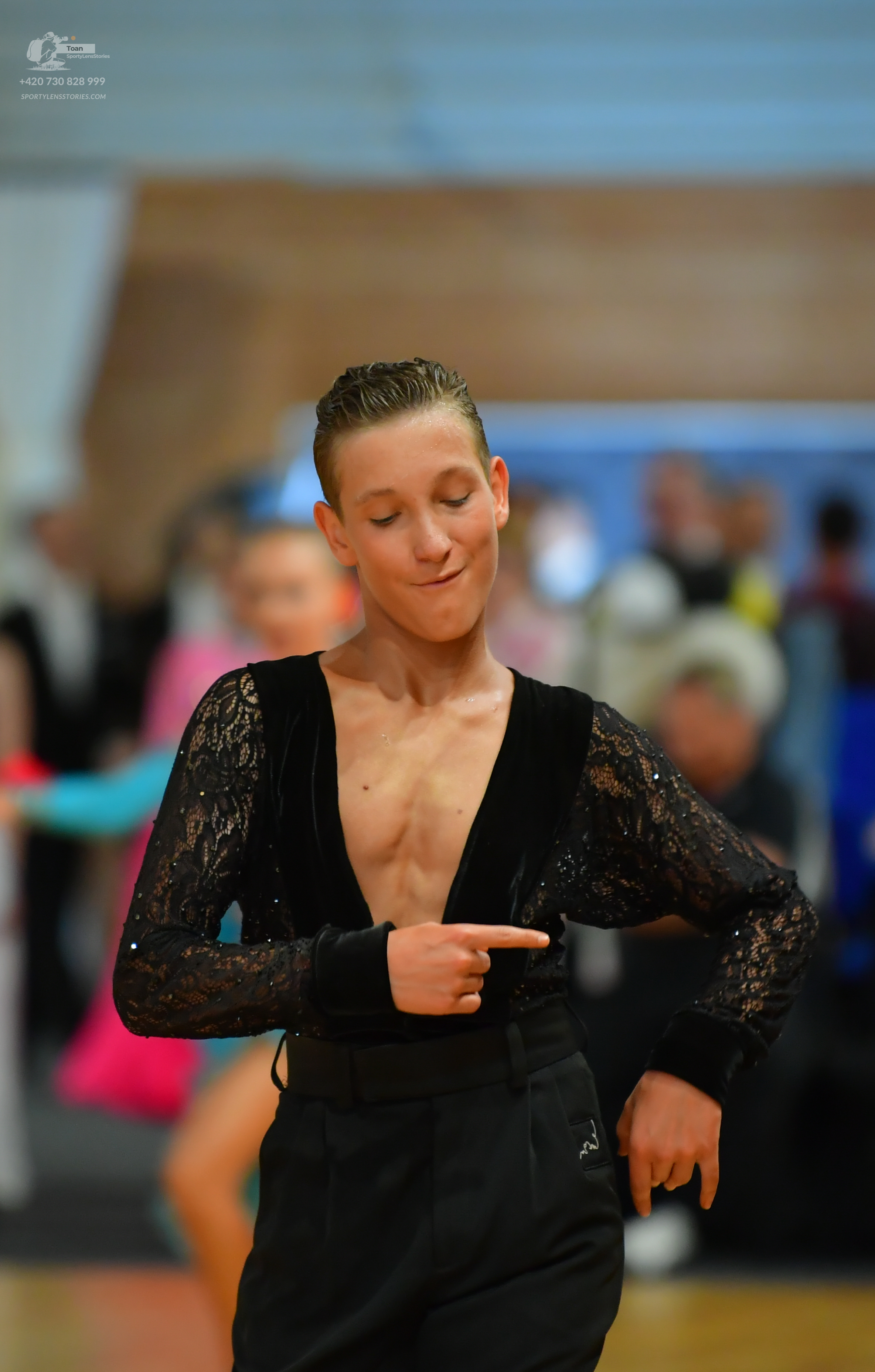 Dancesport competitor: Male: Black sequin tailsuit with a black harness and black shorts