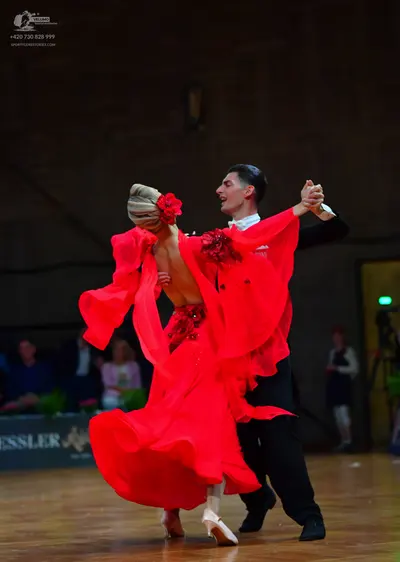 Dancesport competitor: Male dancer: black suit with a white shirt