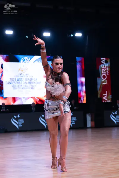 Dancesport competitor: Female dancer: silver metallic latin dance costume with a sequined and lace bodi