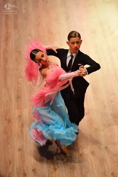 Dancesport competitor: Male dancer: black suit with a white shirt and black tie